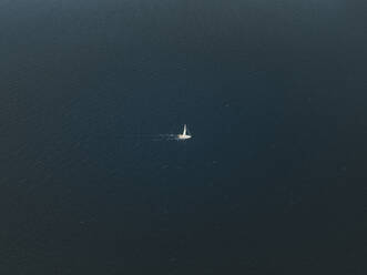 Aerial view of a boat sailing in the sea of Sicily, Italy. - AAEF28679