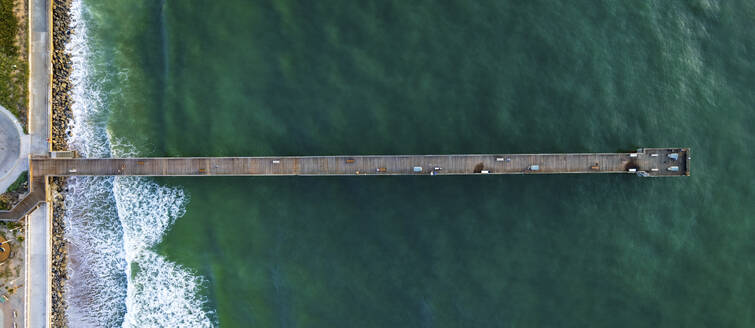 Aerial view of sunny Saint Augustine Beach with turquoise waters and coastal pier, Florida, United States. - AAEF28696