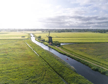Aerial drone view of kayak and Dutch windmill near the city of Alkmaar, The Netherlands. - AAEF28720