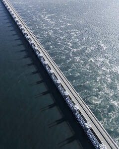 Aerial drone view of storm surge barrier Oosterscheldekering, bridge and water barrier, The Netherlands. - AAEF28735