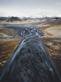 Aerial view of a braided river leading up to a mountain range near Vik, Iceland. - AAEF28766