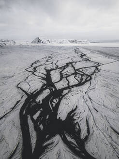 Aerial view of a braided river leading up to a mountain near Vik, Iceland. - AAEF28769