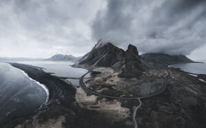 Aerial view of Eystrahorn and a black sand beach stretching along the coast in Hvalnes Nature reserve, Austurland, Iceland. - AAEF28780