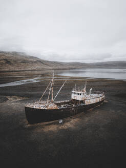 Aerial view of the Gardar BA 64 shipwreck laying on the Patreksfjordur fjord shoreline, Westfjords, Iceland. - AAEF28783