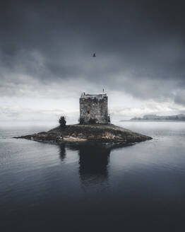 Aerial view of a bird flying over Castle Stalker, County of Argyll, Scotland. - AAEF28790