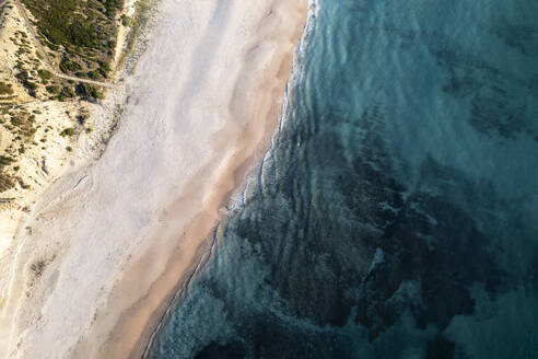 Aerial view of a white sandy beach from above with calm turquoise blue water, Port Willunga, South Australia, Australia. - AAEF29042