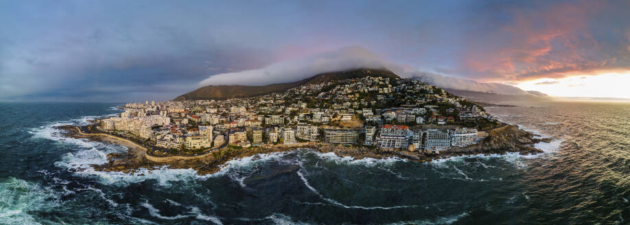 Panoramablick auf Bantry Bay und niedrige Wolken über dem Lion's Head Mountain mit dem Tafelberg im Hintergrund bei Sonnenuntergang, Bantry Bay, Kapstadt, Südafrika. - AAEF29072