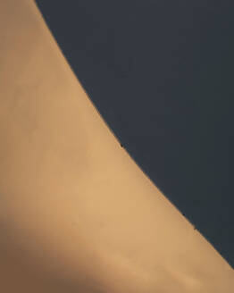 Aerial view of a person walking on a sand dune in De Ica desert sand dunes, Huacachina, Ica, Peru. - AAEF29374