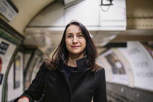 Mature woman traveling at subway station - AMWF02093