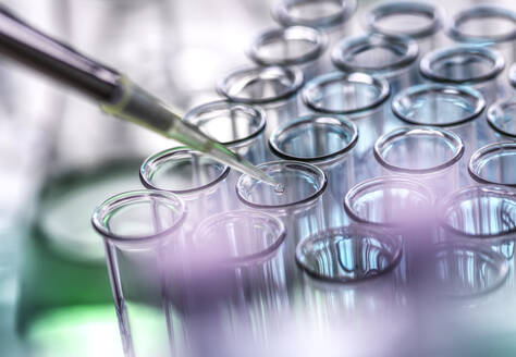 Scientist pipetting sample in test tubes at lab - ABRF01174