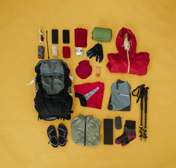 Travel kit for hiking organized on yellow background - OSF02463