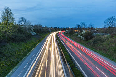 Germany, Baden-Wurttemberg, Stuttgart, Vehicle light trails along Bundesstrasse 14 at dusk - WDF07558