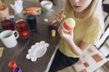 Girl coloring and decorating eggs for Easter - SIF01079