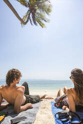 Couple relaxing on beach at sunny day - IKF01777