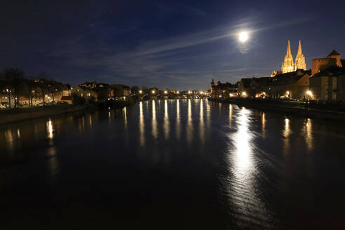 Germany, Bavaria, Regensburg, River flowing through historic old town at night - JTF02419