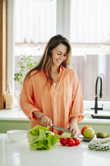 Russia. Woman chopping vegetable in the kitchen - OLRF00260
