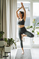 Russia. Middle age woman practicing yoga at home - OLRF00271