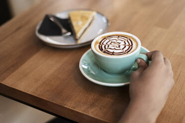 Spain, African woman having coffee, Relax - LMCF01123