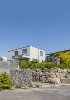 Switzerland, St Gallen Canton, Kaltbrunn, Clear sky over modern energy efficient suburban house - MAMF03066