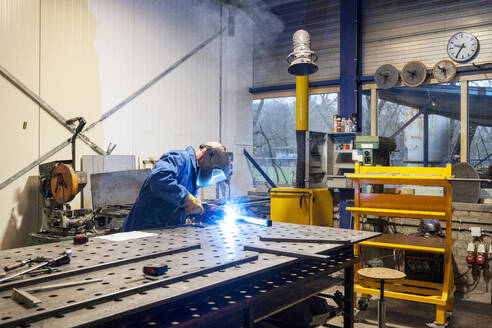 Man welding metal together for a client - ISF26782