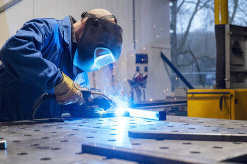 Man welding metal together for a client - ISF26783
