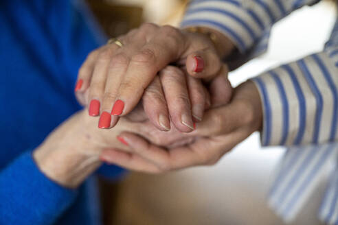 Two elderly ladies holding hands close up - ISF26835