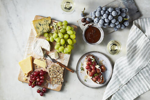 A gourmet cheese and fruit platter paired with wine on a leisurely afternoon. - ISF26992