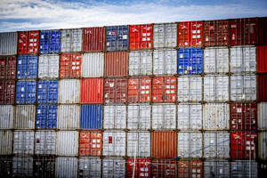 Vibrant maze of stacked shipping containers under a blue sky. - ISF27319