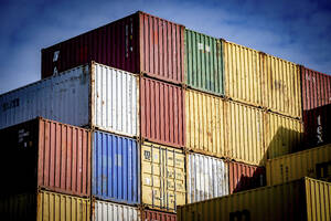 Stacks of colorful shipping containers against a vivid sky. - ISF27320