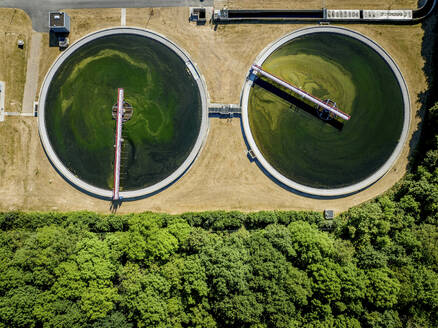 Overhead view of circular water treatment basins surrounded by greenery - ISF27362