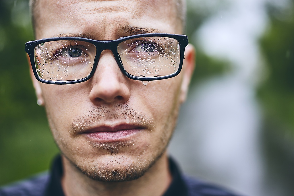 Close-Up Of Man Wearing Eyeglasses During Rainy Season