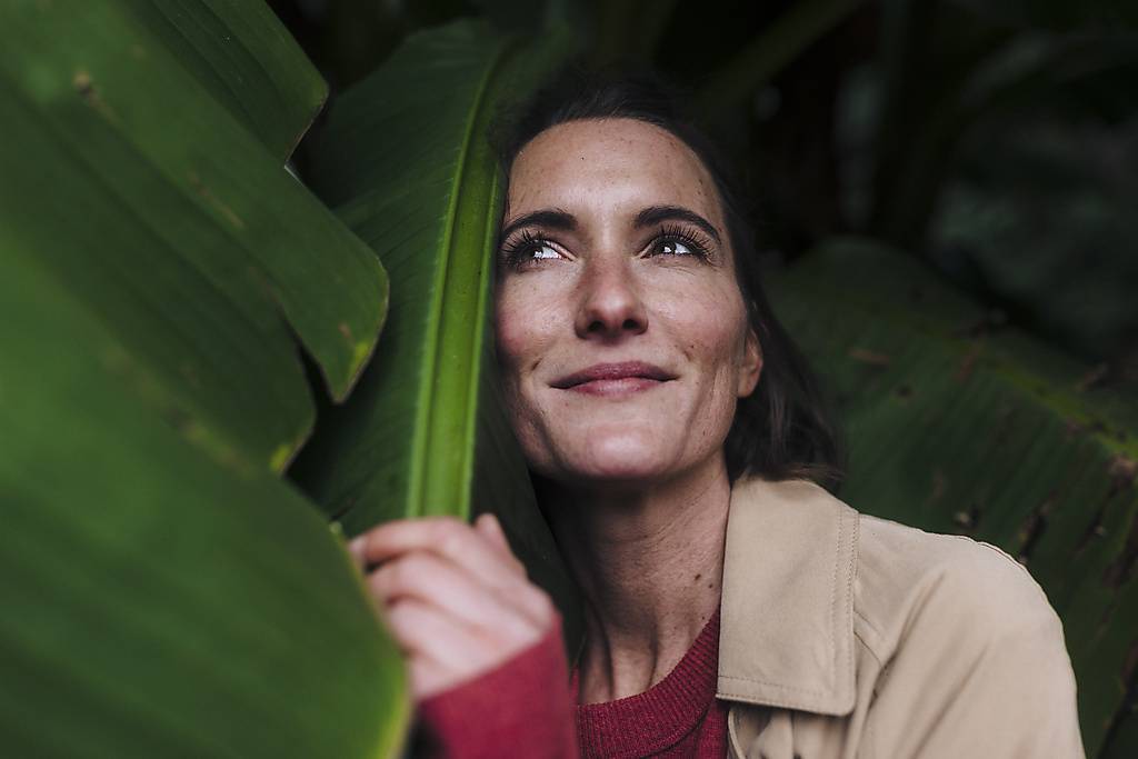 Thoughtful woman with banana leaf