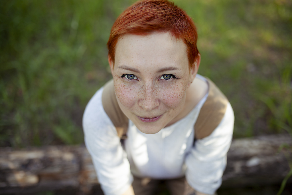 Portrait of smiling woman sitting on grass